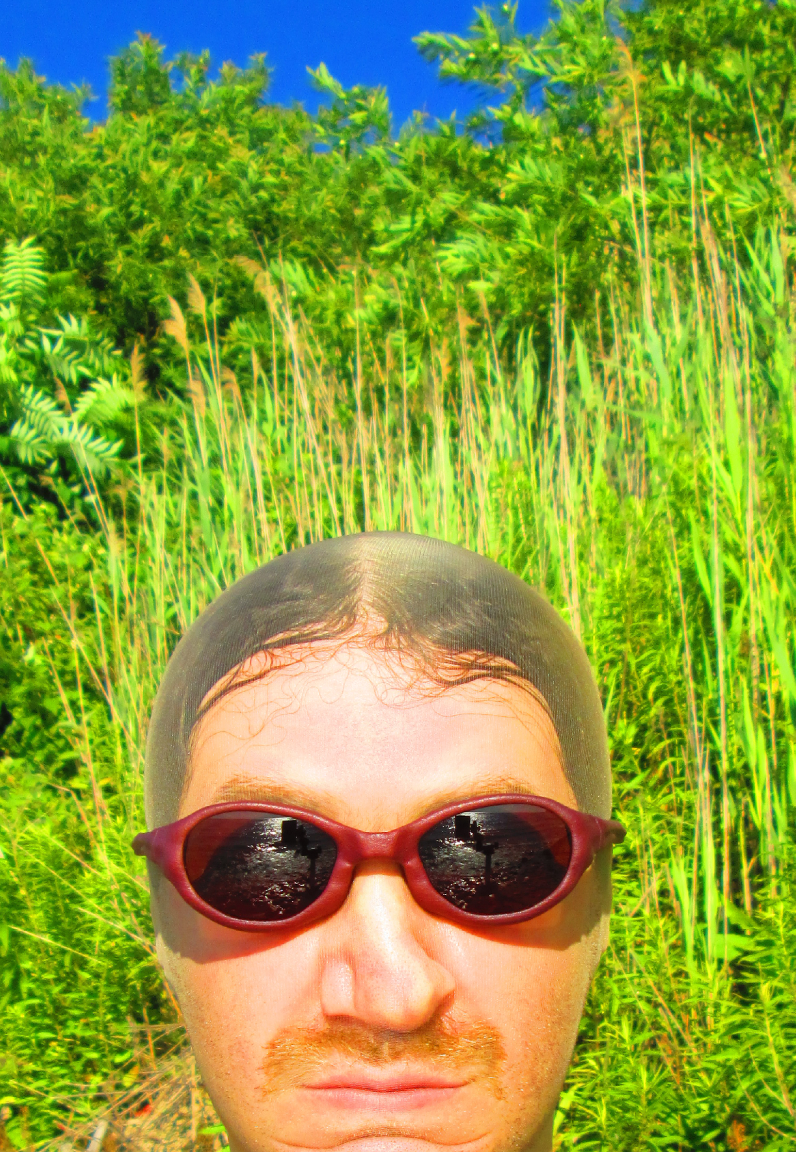 3D render of a bald model wearing black sunglasses with transparent grey lenses